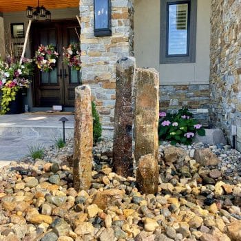 Pillar fountain feature in front yard garden landscaping bed
