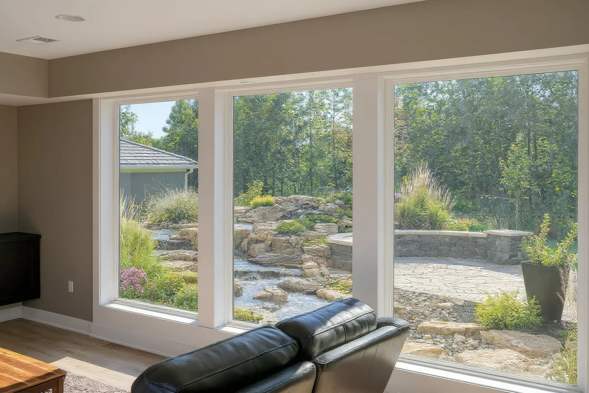 The waterfall seen through the tall back windows of the home that was designed around it